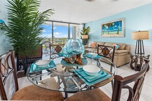 Enjoy meals with friends and family in this inviting dining area, featuring a round table and comfortable seating for four.