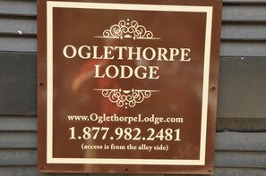 A sign for Oglethorpe Lodge with the website and phone number. - 1bd, 1.5ba Historic District and River Front-Walk to Everything! (Savannah)