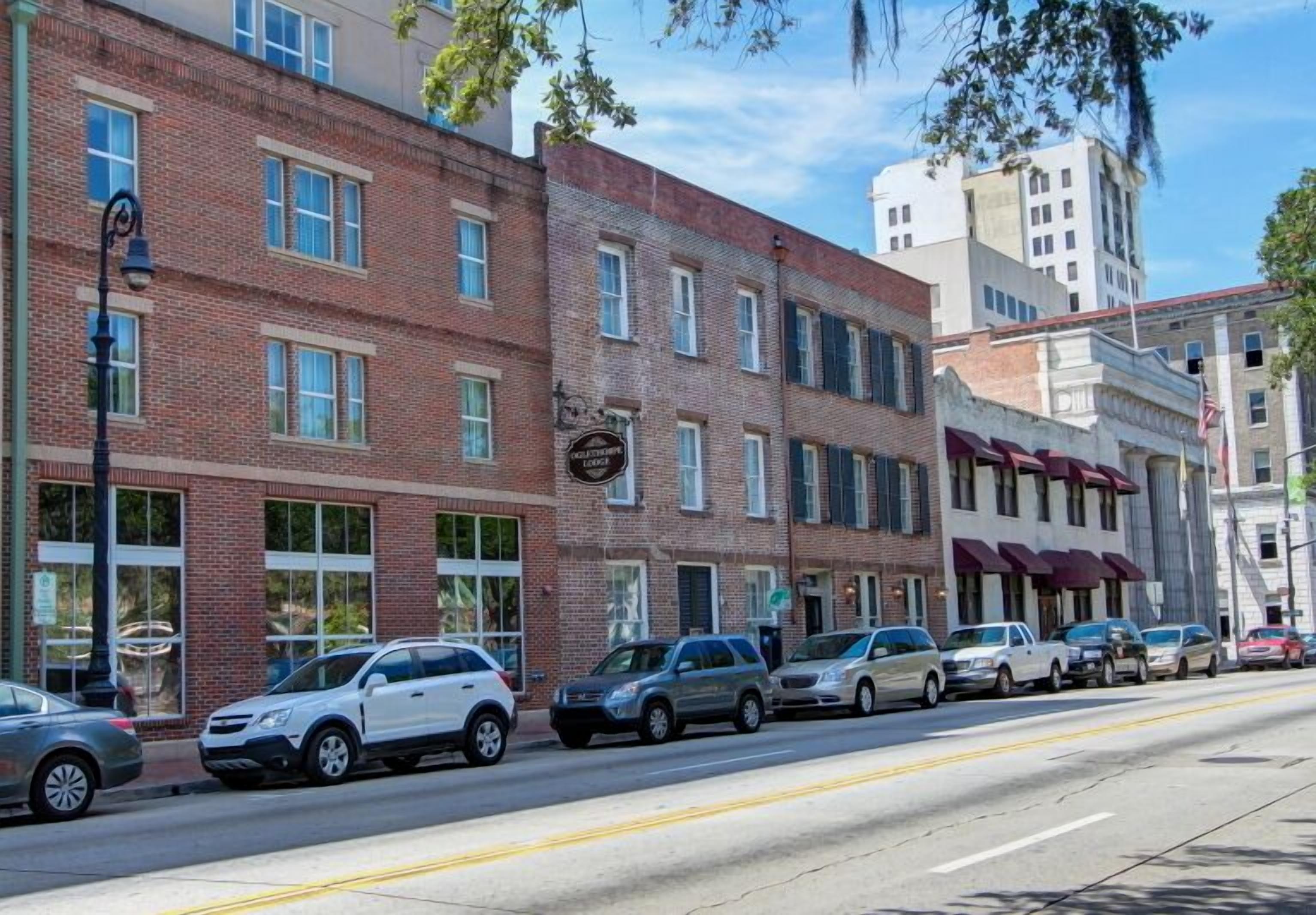 A row of brick buildings with storefronts, including a visible sign for a business named "Lodge."