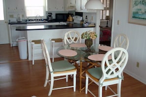 Compact kitchen with dining area, featuring a microwave, toaster, and coffee maker.