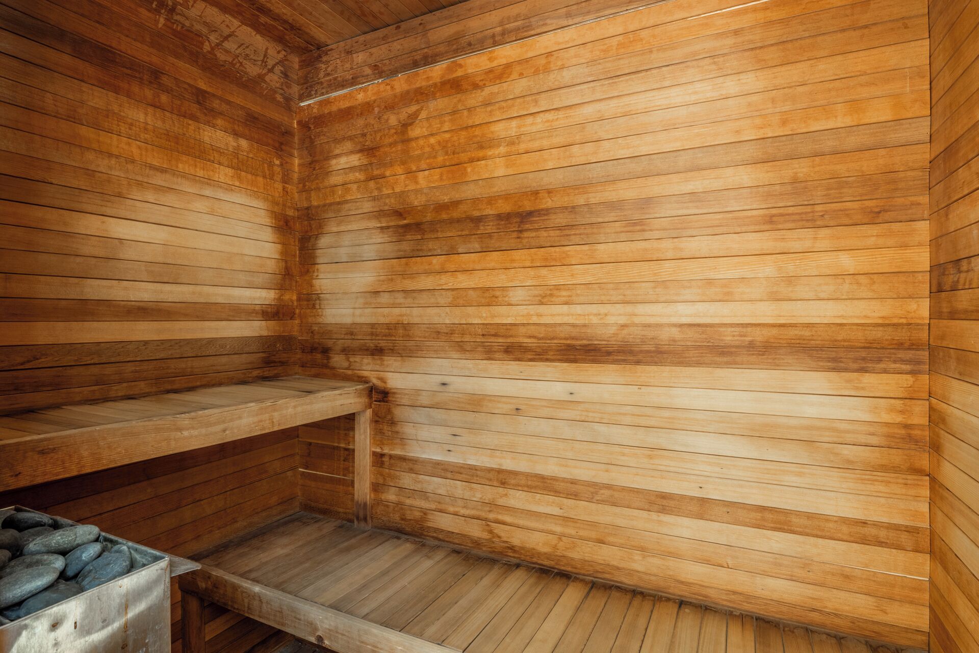 A sauna with wooden walls and benches.