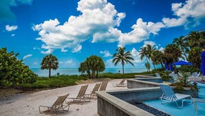 A pool area with lounge chairs and a view of the ocean. - Key West Beachfront Luxury 2/2 Condo A212   (Key West)