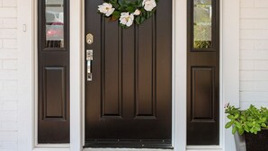 A dark brown front door with a white doorbell and a doormat that reads "Welcome". - Old Town Scottsdale All around VACATION experience! Heated Pool & Media Room (Scottsdale)