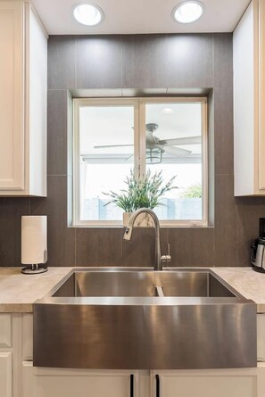 A roomy kitchen sink with views of the backyard. - Pool House Scottsdale | Play Starts Here! (Scottsdale)