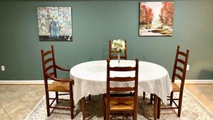 A dining area with a round table, four wooden chairs, and two paintings on the wall. - MOUNT VERNON RETREAT 🌸 (Alexandria)