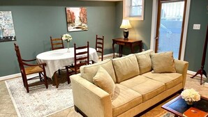 A living room with a beige sofa, wooden chairs, a dining table with a white tablecloth, and a lamp. - MOUNT VERNON RETREAT 🌸 (Alexandria)