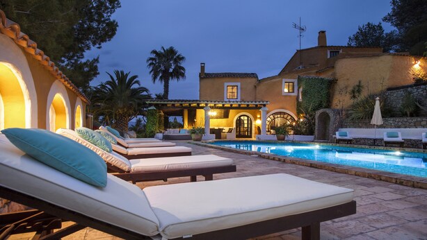 A poolside area with lounge chairs and a swimming pool.
