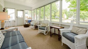 A sunlit room with white wicker furniture, large windows, and a ceiling fan. - (Aug 08-14 open!) LAKESIDE HOME CLOSE TO PRIVATE ASSOCIATION BEACH! (Lakeside)