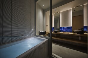 Enjoy a relaxing soak in the large bathtub and glass-enclosed shower area.