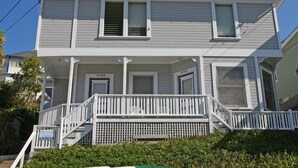 A two-story house with a porch, a chimney, and a small garden area. - 216WA: Budget-friendly Apartment in Victorian Triplex, 2 Blocks to the Beach + W (Avalon)