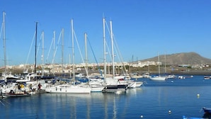 A marina with multiple sailboats docked. - Spring Apartment  (Costa del Silencio)