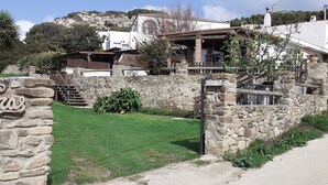 A stone-walled property with a sign reading "Privado," a small grassy area, and a paved path. -  House with sea views. Free WIFI. Punta Paloma, Tarifa (Tarifa)
