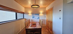 Stunning hallway leads to a dining area with a wooden table and chairs.