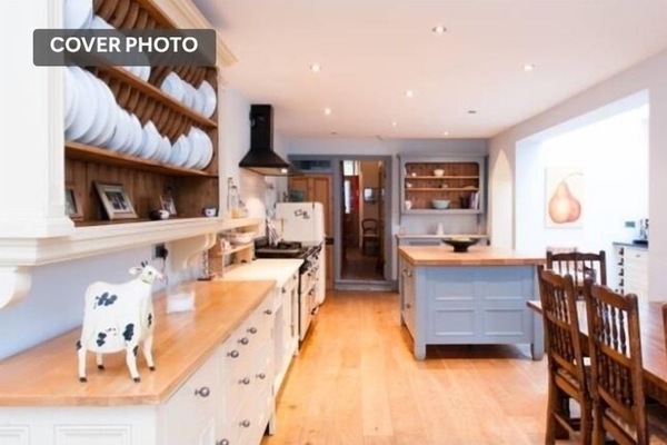 Large kitchen with doors out to lovely walled garden