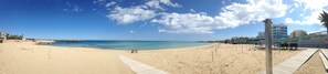 A beach with a wooden walkway and a pier. -   Sea  and Sun rise views. Villa with private pool and gated children Play Area. (paralimni)