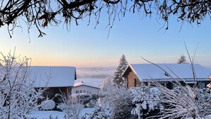 A snowy landscape with a house and a tree. - Adventure and Relaxation for you and your family in the Southern Bavarian Forest (Windorf)