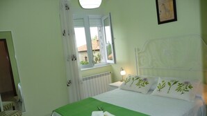 A bedroom with a bed, a window, a radiator, a chair, and a lamp. - APARTMENT FOR 4 PEOPLE IN LIENCRES (Liencres)