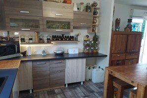 Enjoy cooking and dining in this well-equipped kitchen with microwave, coffee machine, and ample storage.