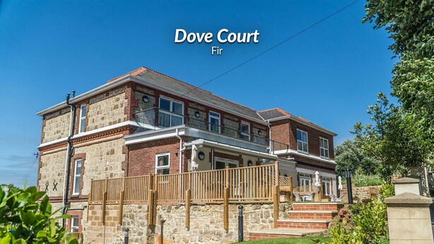 A two-story building with a stone facade and a balcony, labeled 'Dove Court Fir'.