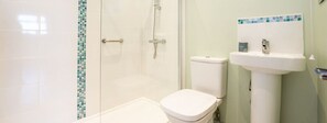 A bathroom with a shower, toilet, and sink. - Vectis Holiday Homes, Modern, spacious apartment, great location, EV Charging (Shanklin, Isle of Wight)