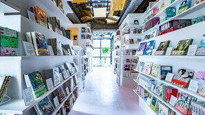 A modern bookstore with white shelves filled with books and magazines. - MANGA ART HOTEL, TOKYO - Hostel (Tokyo)