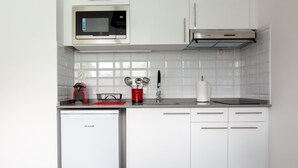 A modern kitchen with a built-in microwave, a Bosch dishwasher, and a stainless steel range hood. - Beautiful 3-room apartment in the heart of the marina, 3 minutes from the beaches  (Les Trois-Îlets)