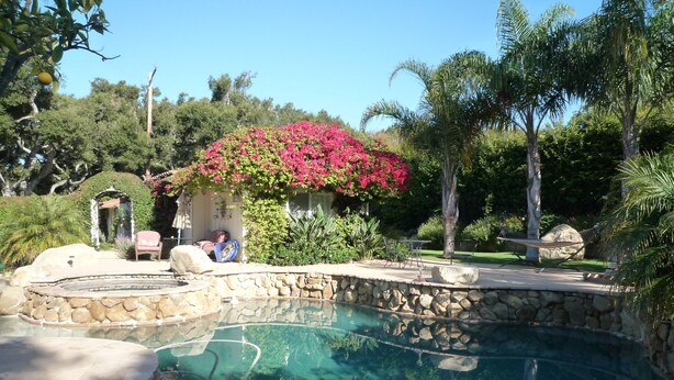 A swimming pool with a stone border, surrounded by lush greenery and a gazebo. - Room 4 Two in Montecito/ Santa Barbara (Montecito)
