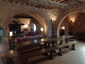 A rustic interior with exposed brick arches, wooden benches, and a fireplace. - Podere Tresa: A Villa on the Umbria-Tuscany Border for Families and Friends - Private Pool (Città della Pieve)