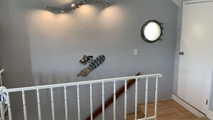 A staircase with a white railing leading to a door. - Fun at the Beach !!!!!! (Oxnard)