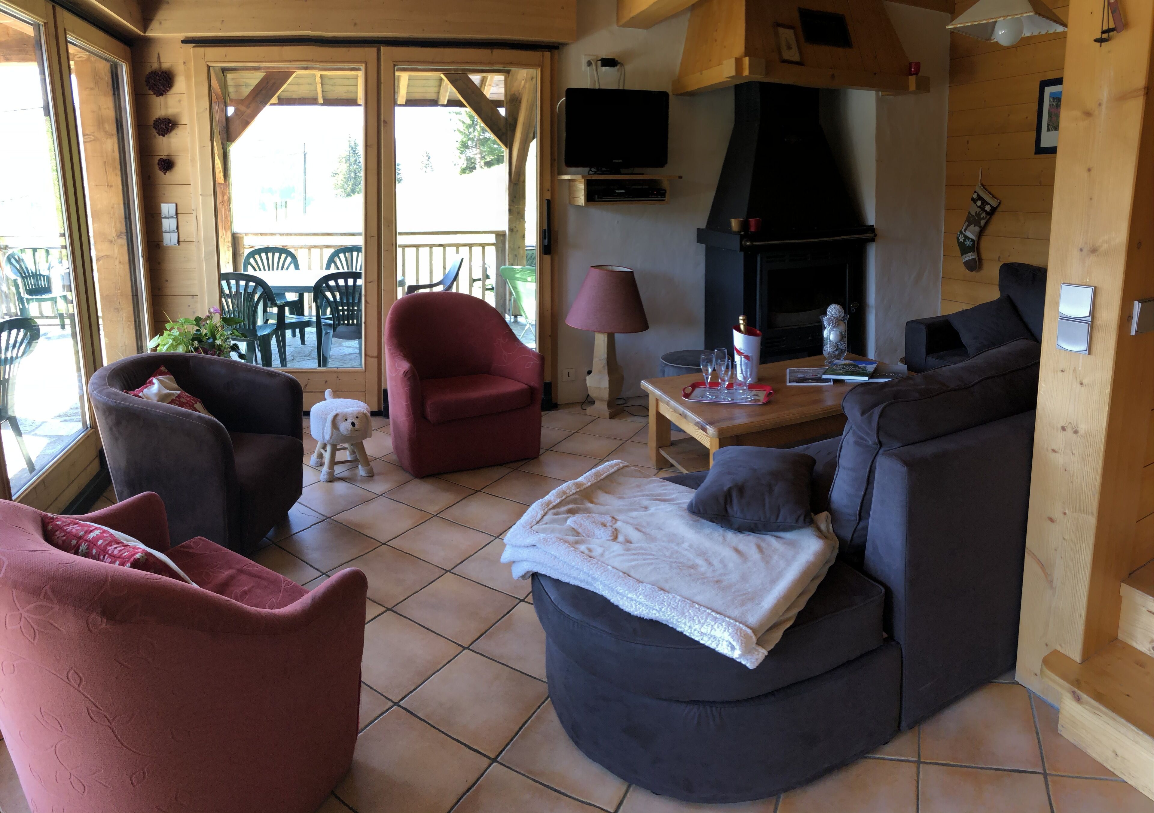 A cozy living room with a fireplace, comfortable seating, and a television.