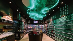 A well-lit store with shelves stocked with various beer bottles and glasses. - Viuter - Marina Vista Puerto Rico (Mogán)