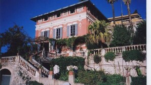 A large, two-story building with a balcony and a staircase leading to the entrance. - House / Villa - Menton (Menton)