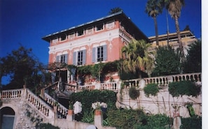 A large, two-story building with a balcony and a staircase leading to the entrance. - House / Villa - Menton (Menton)