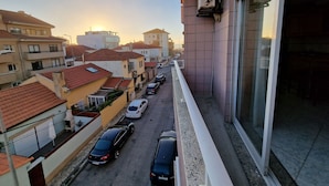 A residential area with multiple buildings, a street with parked cars, and a clear sky. - "Beachfront apartment - Praia do Furadouro with Wi-Fi" (Ovar)