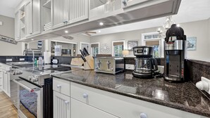 Una cocina moderna con electrodomésticos de acero inoxidable, cafetera y tostadora.