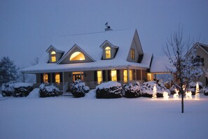 A snow-covered house with multiple windows and a porch. - Cozy, Fully Furnished Mountain Retreat – Perfect for Nature Lovers! (Pisgah Forest)