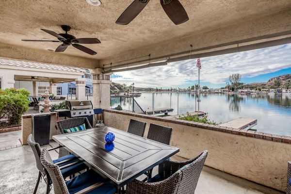 Open the living room doors to access the patio area with BBQ at River Front
