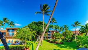 A resort with multiple buildings, palm trees, and a pool area. - Where Families Gather Kihei 2BR Loft Condo Heated Pool Hot Tub Near Beach (Kihei)