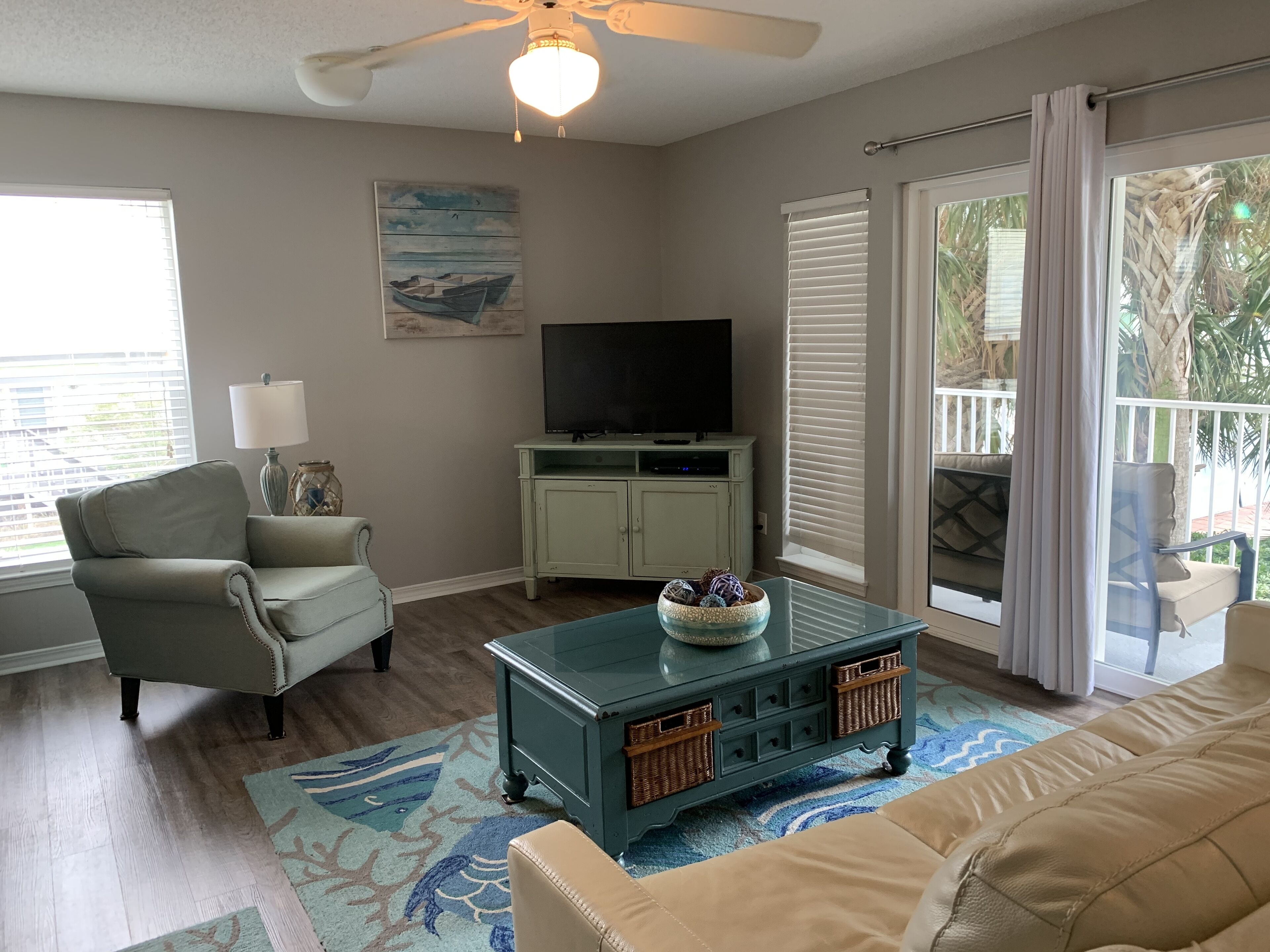 Beachy, inviting living room that includes a queen sleeper sofa 