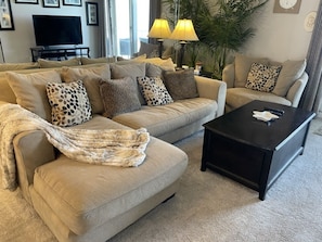 Relax in this stylish living room with a comfortable sofa, coffee table, and large window.