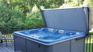 A hot tub on a deck with steps leading up to it. - Elegant 2 King Bedroom Apt - 2 night minimum - 4 adults  (Traverse City)
