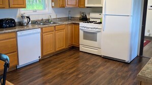 A kitchen with wooden cabinets, a microwave, a refrigerator, a stove, and a dishwasher. - Large Home with Outstanding Views & Location (Palmer)