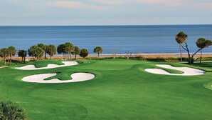 A golf course with sand bunkers and palm trees, overlooking the ocean. - Great Lagoon, Tennis+pool View Townhome W/10min Walk To Golf+Beach+Harbour Town (Hilton Head Island)