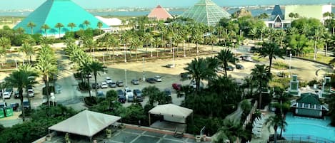 A resort with multiple pyramid-shaped buildings, a parking area, and a swimming pool.