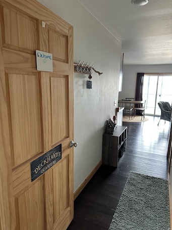 A wooden door with a sign reading "Welcome" and "Deckhand's Quarters."