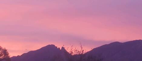 A mountain range with a pink sky.