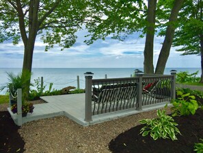 A wooden deck with a metal railing overlooking a body of water. - Spectacular Panoramic Lake Views in Romantic, Private Setting (Waterport)