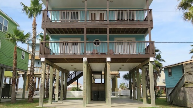 A two-story building with a balcony on the upper level.