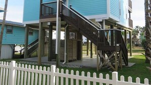 A two-story house with a balcony and a staircase leading to the upper floor.