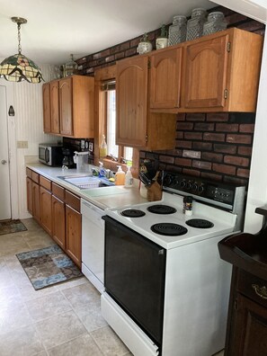 Enjoy cooking in this well-equipped kitchen with a stove, microwave, and coffee maker.